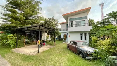 an old car parked in front of a house at The Endless Bangtao Residence CHAT 2 in Bang Tao Beach