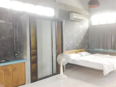 a bedroom with a bed and a fan in it at The Endless Bangtao Residence CHAT 2 in Bang Tao Beach
