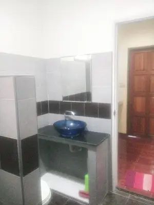 a bathroom with a blue sink and a mirror at The Endless Bangtao Residence VC 1 in Bang Tao Beach