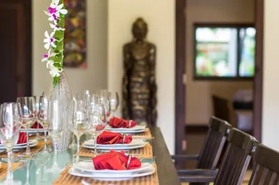a table with wine glasses and red napkins on it at Viola Pool Villa Elegant Elegant Villa In Paradise in Rawai Beach
