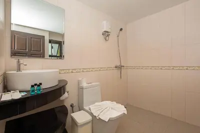 a bathroom with a sink and a toilet and a mirror at Baan Chom View Kamala - SHA Plus in Kamala Beach