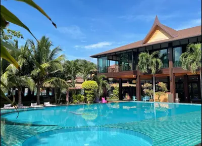a large swimming pool in front of a building at Phi Phi Villa Resort in Phi Phi Don