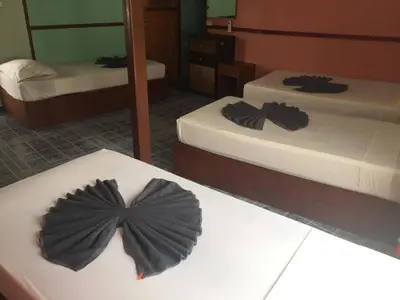 a room with two beds and a bow tie on a table at Scenery Guest House in Phi Phi Don