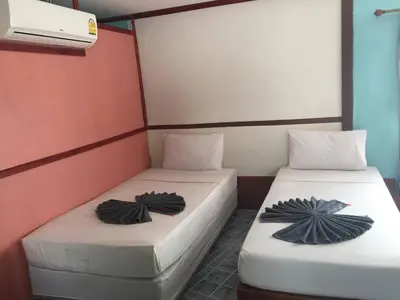 two beds sitting next to each other in a room at Scenery Guest House in Phi Phi Don