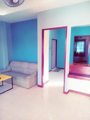 a living room with a white couch and blue walls at The Endless Bangtao Residence VC 2 in Bang Tao Beach