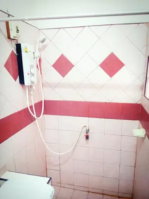 a bathroom with a shower with a hose at The Endless Bangtao Residence VC 2 in Bang Tao Beach