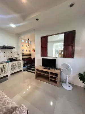 a living room with a fan and a mirror at The Endless Bangtao Residence CAC 3 in Bang Tao Beach