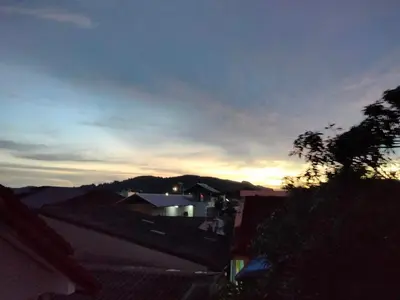 a view of a city with the sunset in the sky at mom's home in Phuket Town