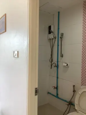 a bathroom with a shower with a toilet in it at mom's home in Phuket Town