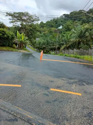 a orange fire hydrant in the middle of a street at mom's home in Phuket Town