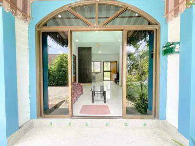 a large glass door of a house with a patio at The Endless Bangtao Residence Wat 1 in Bang Tao Beach