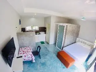 a living room with a couch and a table at The Endless Bangtao Apartment AC1234 in Bang Tao Beach