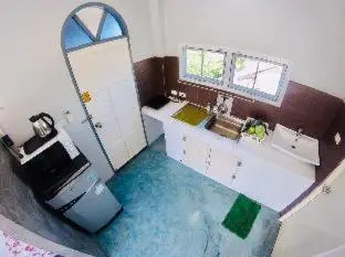 a bathroom with a blue floor and a mirror at The Endless Bangtao Apartment AC1234 in Bang Tao Beach