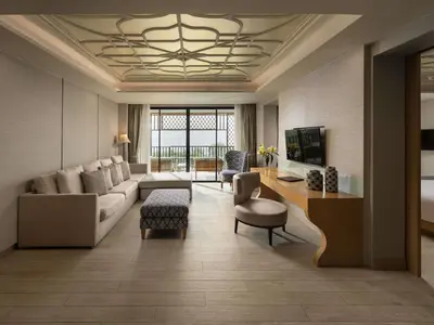 a living room with a couch and a table at Avista Grande Phuket Karon - MGallery in Karon Beach