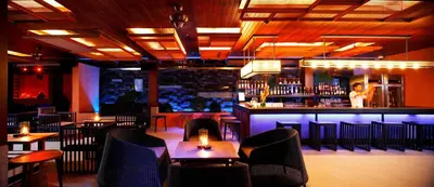 a restaurant with tables and chairs and a bar at Sri Panwa Phuket Luxury Pool Villa Hotel in Panwa Beach