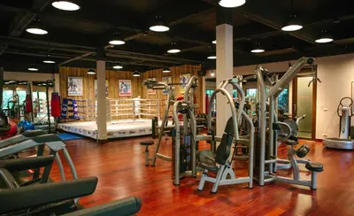 a gym with a bunch of treadms and machines at Sri Panwa Phuket Luxury Pool Villa Hotel in Panwa Beach