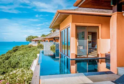 a house with a swimming pool next to the ocean at Sri Panwa Phuket Luxury Pool Villa Hotel in Panwa Beach