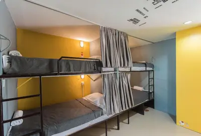 a room with three bunk beds in it at Backpacker Street Airport Place in Nai Yang Beach