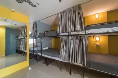 a group of bunk beds in a room at Backpacker Street Airport Place in Nai Yang Beach