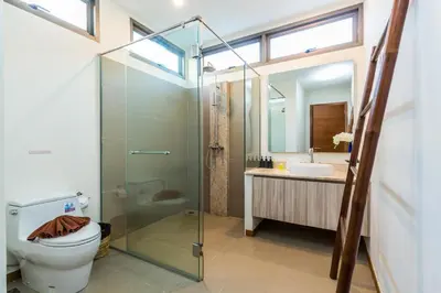 a bathroom with a shower and a toilet and a sink at Ka villa private pool & maid by Lofty in Rawai Beach