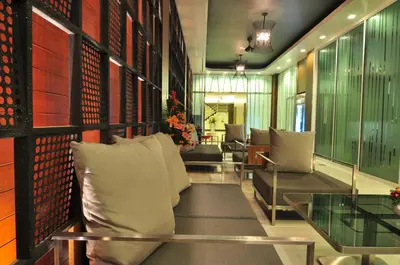 a living room with a couch and a glass table at Platinum Hotel and Apartments in Patong Beach