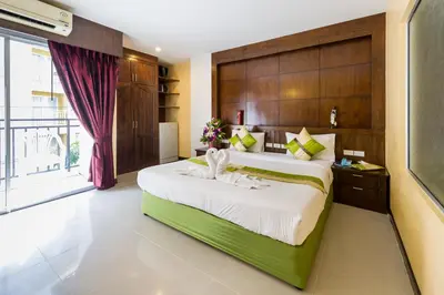 a bedroom with a large bed and a window at Thai Siam in Patong Beach