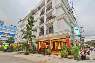 a white building with plants in front of it at Thai Siam in Patong Beach