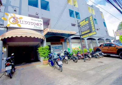 a group of motorcycles parked in front of a building at Summer Hotel in Phuket Town
