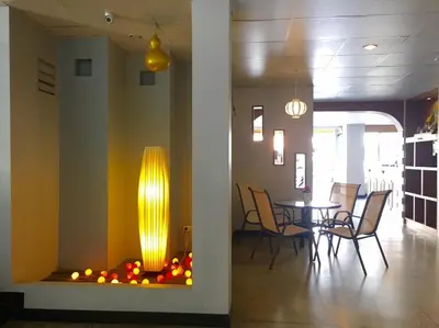 a dining room with a table and a fire place at Summer Hotel in Phuket Town
