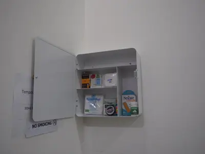 a white medicine cabinet with a door open at Sleepwell@naiyang in Nai Yang Beach