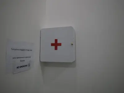 a white switch with a plus sign on a wall at Sleepwell@naiyang in Nai Yang Beach