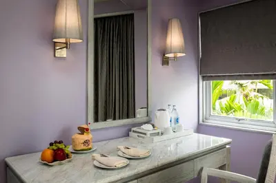 a dining room table with a mirror and fruit on it at Aonang Villa Resort l Lifestyle Beachfront Resort in Ao Nang Beach