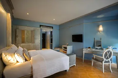 a bedroom with a white bed and a desk at Aonang Villa Resort l Lifestyle Beachfront Resort in Ao Nang Beach