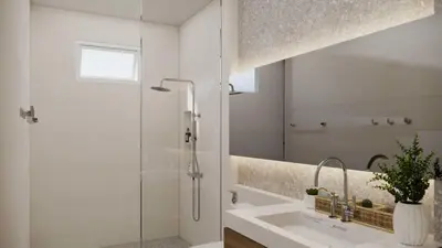 a white bathroom with a shower and a sink at Phi Phi Andaman Legacy Resort in Phi Phi Don
