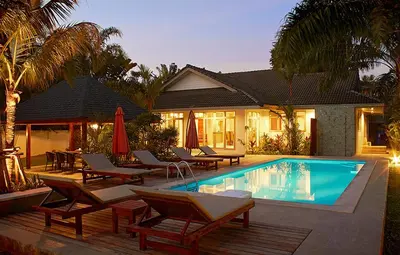 a swimming pool with lounge chairs and a house at Villa Raeya in Ao Nang Beach