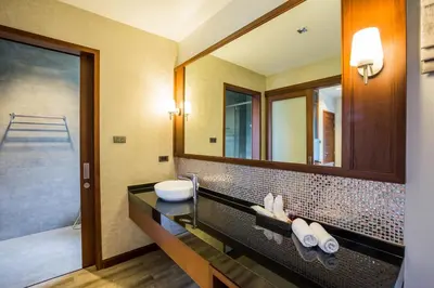a bathroom with a sink and a mirror at Villa Raeya in Ao Nang Beach