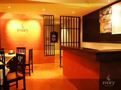 a restaurant with a bar with a table and chairs at Ivory Phi Phi Island in Phi Phi Don