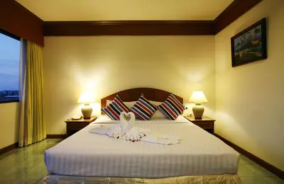 a hotel room with a bed with a towel on it at Jiraporn Hill Resort in Patong Beach