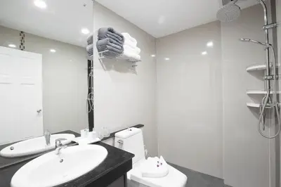 a white bathroom with a sink and a toilet at Modern Living Residence in Patong Beach