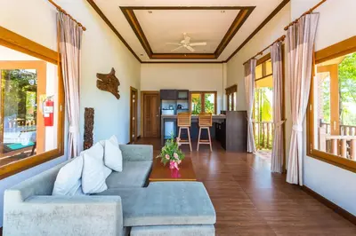 a living room with a couch and a table at Chalong Chalet Resort in Chalong