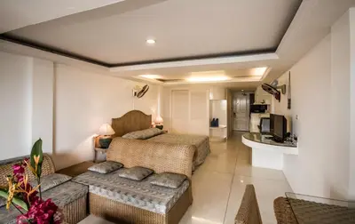 a living room with two beds and a couch at Bougainvillea Terrace House in Kata Beach