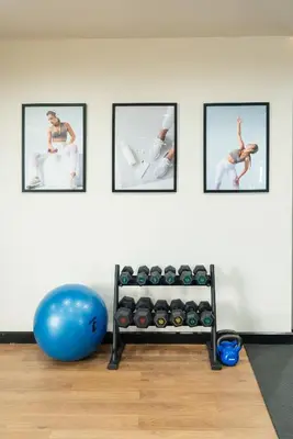 a gym with a fitness ball and a rack of dumbbells at Hotel IKON Phuket - SHA Extra Plus in Karon Beach