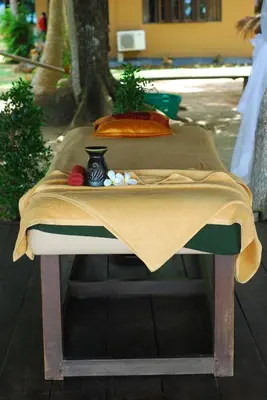 a table with a table cloth on top of it at Melina Beach Front Bungalows in Tha Lane Bay