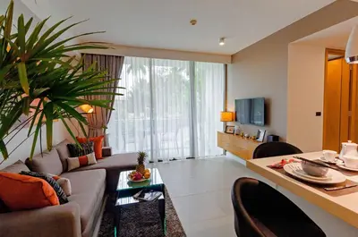 a living room with a couch and a table at Oceanstone by Holy Cow, 2-BR, 60 m2, tree view in Bang Tao Beach