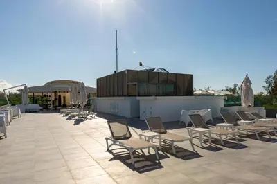 a group of chairs sitting on top of a roof at Oceanstone by Holy Cow, 2-BR, 60 m2, tree view in Bang Tao Beach