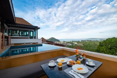 a breakfast table on the balcony of a villa at Andakiri Pool Villa Panoramic Sea View in Ao Nang Beach