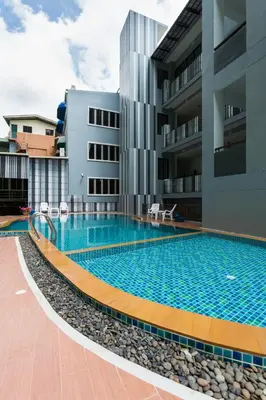 a swimming pool in front of a building at Phranang Place- SHA Extra in Ao Nang Beach