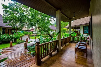 a porch of a house with a wooden deck at Naiyang Park Resort - SHA Extra Plus in Nai Yang Beach