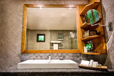 a bathroom with a sink and a large mirror at Naiyang Park Resort - SHA Extra Plus in Nai Yang Beach