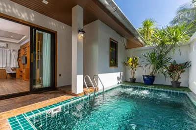 a swimming pool in the backyard of a house at Naiyang Park Resort - SHA Extra Plus in Nai Yang Beach
